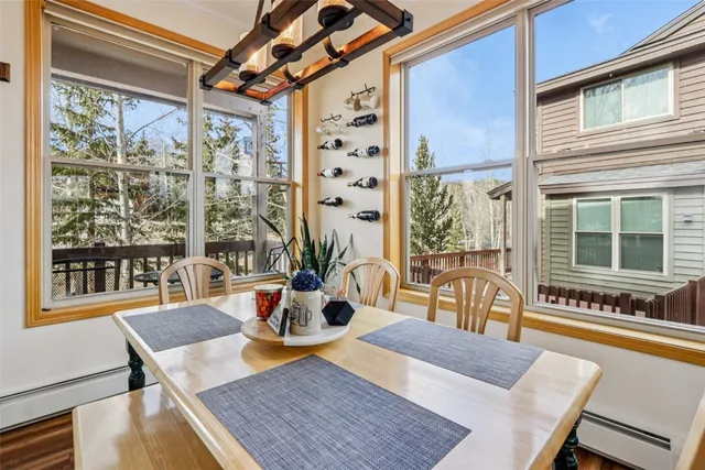 a view of a dining room with furniture large windows and wooden floor