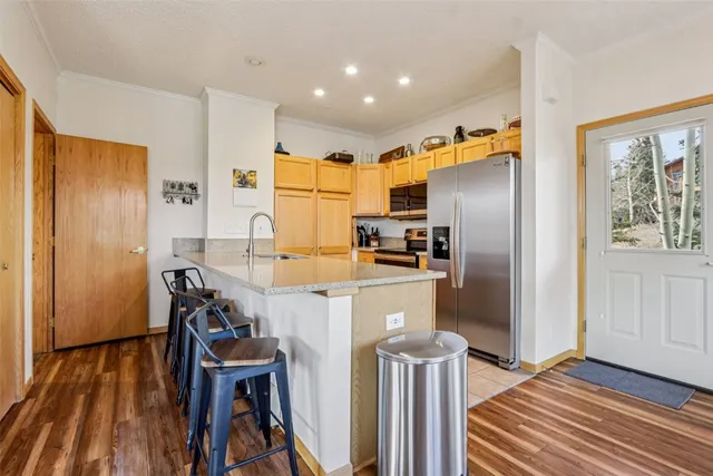 a kitchen with stainless steel appliances a refrigerator and a stove top oven