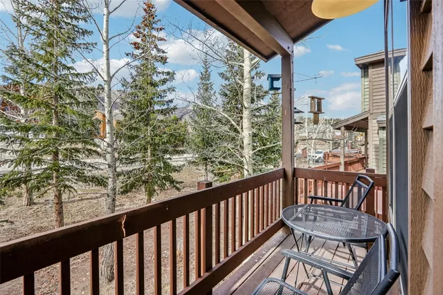 a view of a street sign under a large tree