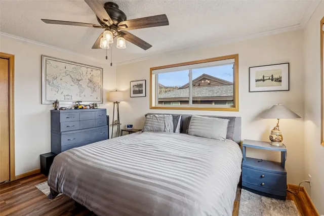 a bedroom with a bed and a painting on the wall