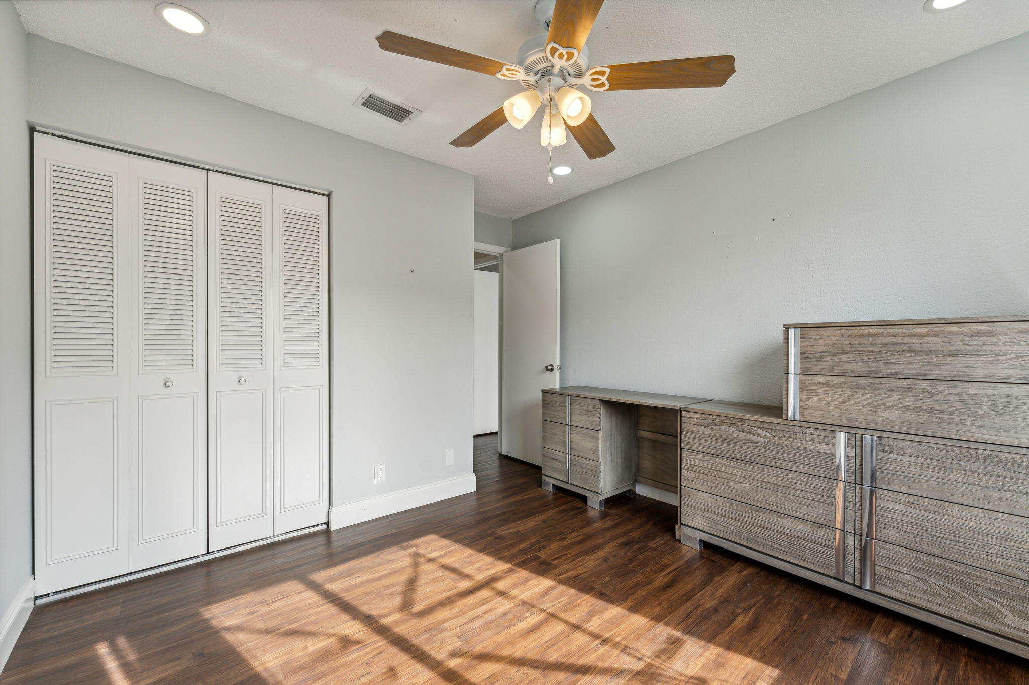 5312 Bosque Lane, Unit 80 West Palm Beach, FL 33415 - Photo 13 of 20 a bedroom with a bed and a ceiling fan