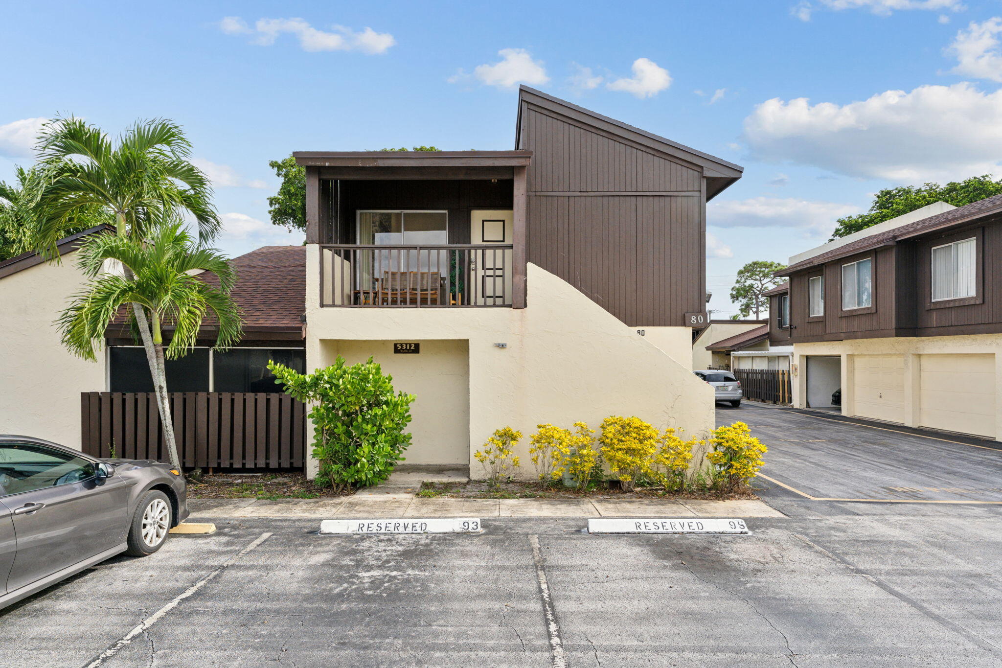 5312 Bosque Lane, Unit 80 West Palm Beach, FL 33415 - Photo 18 of 20 a front view of a house with garden