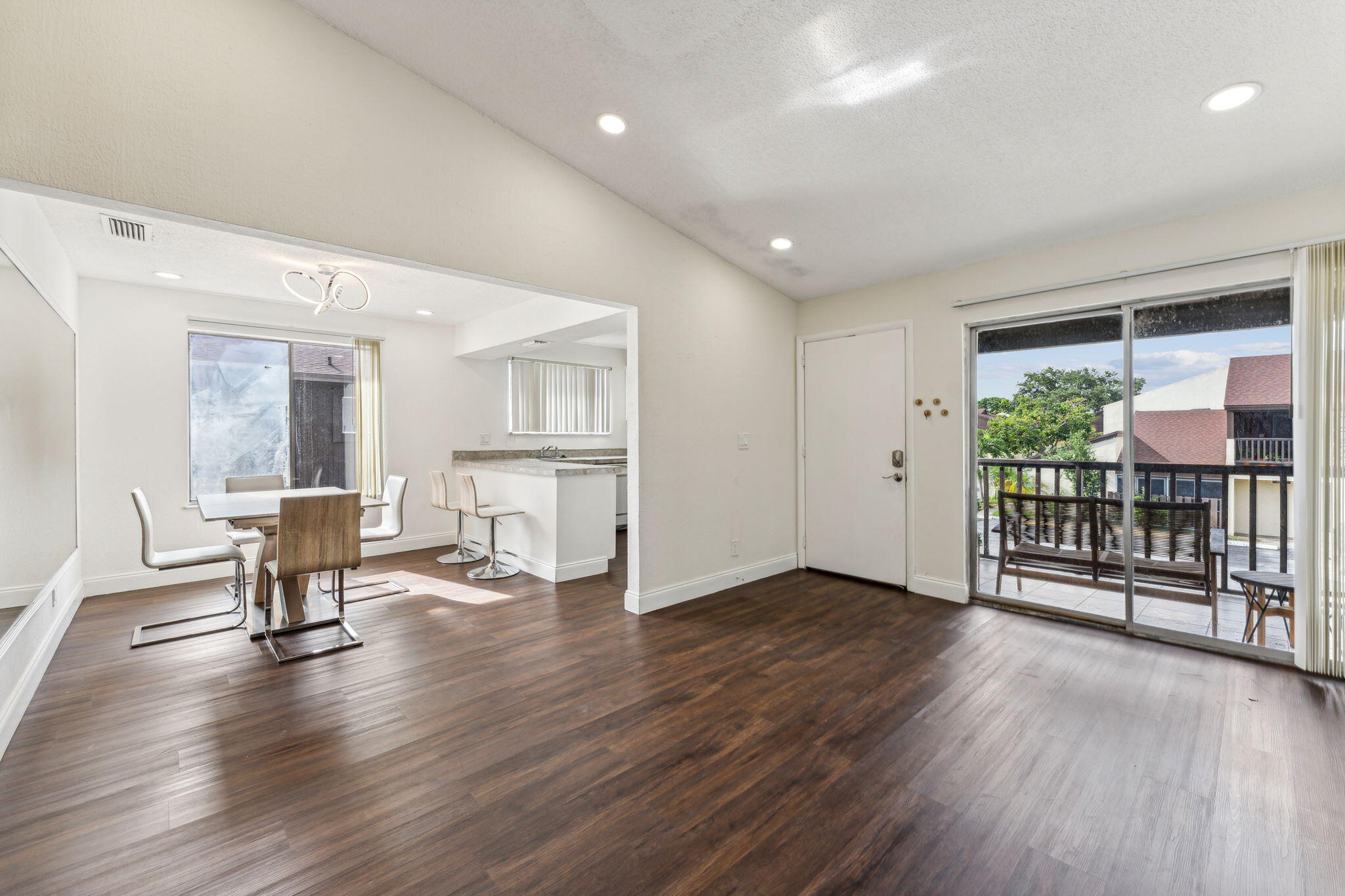 5312 Bosque Lane, Unit 80 West Palm Beach, FL 33415 - Photo 5 of 20 an empty room with wooden floor and windows