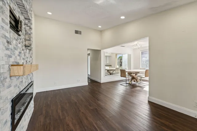 a view of a livingroom with wooden floor and a ceiling fan