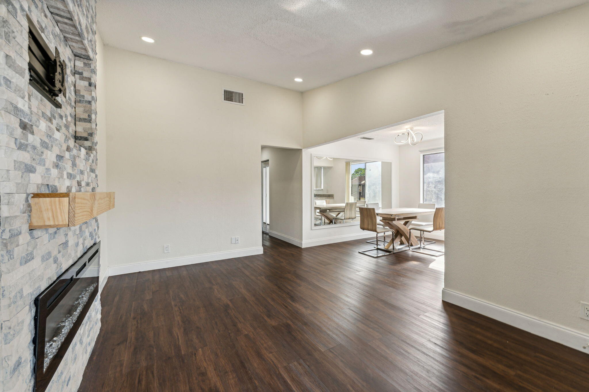 5312 Bosque Lane, Unit 80 West Palm Beach, FL 33415 - Photo 7 of 20 a view of a livingroom with wooden floor and a ceiling fan
