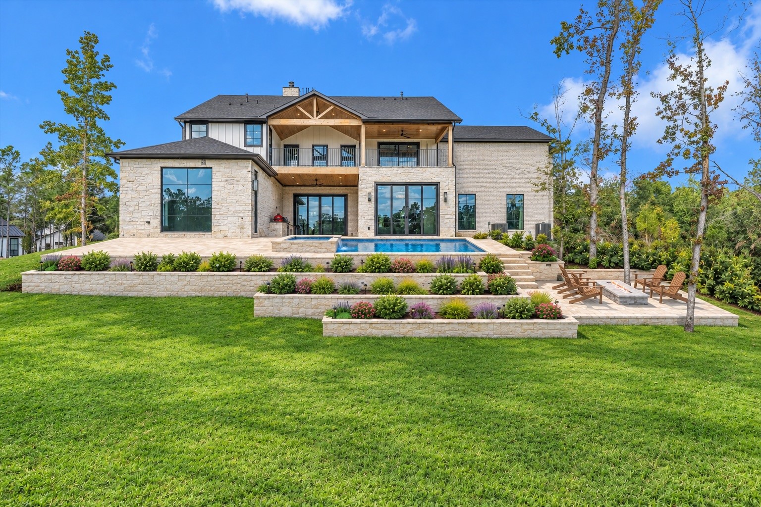 23701 Birch Grove Road Montgomery, TX 77316 - Photo 48 of 50 Experience luxury living with this stunning home's resort-style swimming pool, set amidst beautifully landscaped terraces that offer both elegance and tranquility.