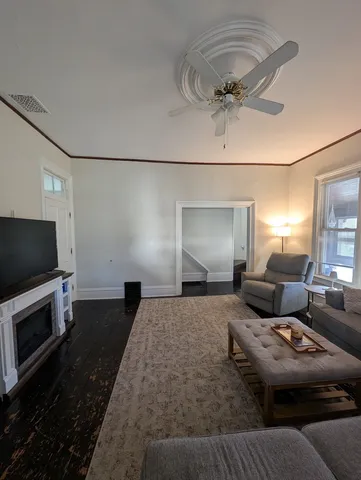 a view of a hallway with a livingroom and furniture