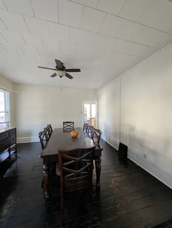 a dining room with a wooden table and chairs