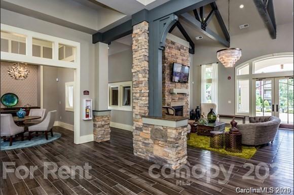 1555 Paddock Club Lane Fort Mill, SC 29715 - Photo 11 of 17 a living room with fireplace furniture and a large window