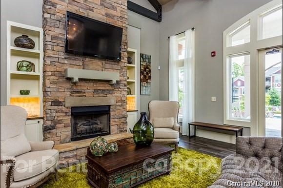 1555 Paddock Club Lane Fort Mill, SC 29715 - Photo 12 of 17 a living room with furniture a flat screen tv and a fireplace