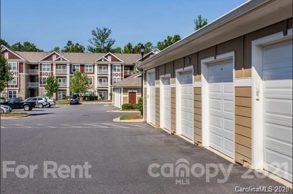 1555 Paddock Club Lane Fort Mill, SC 29715 - Photo 16 of 17 a view of a street with wooden fence