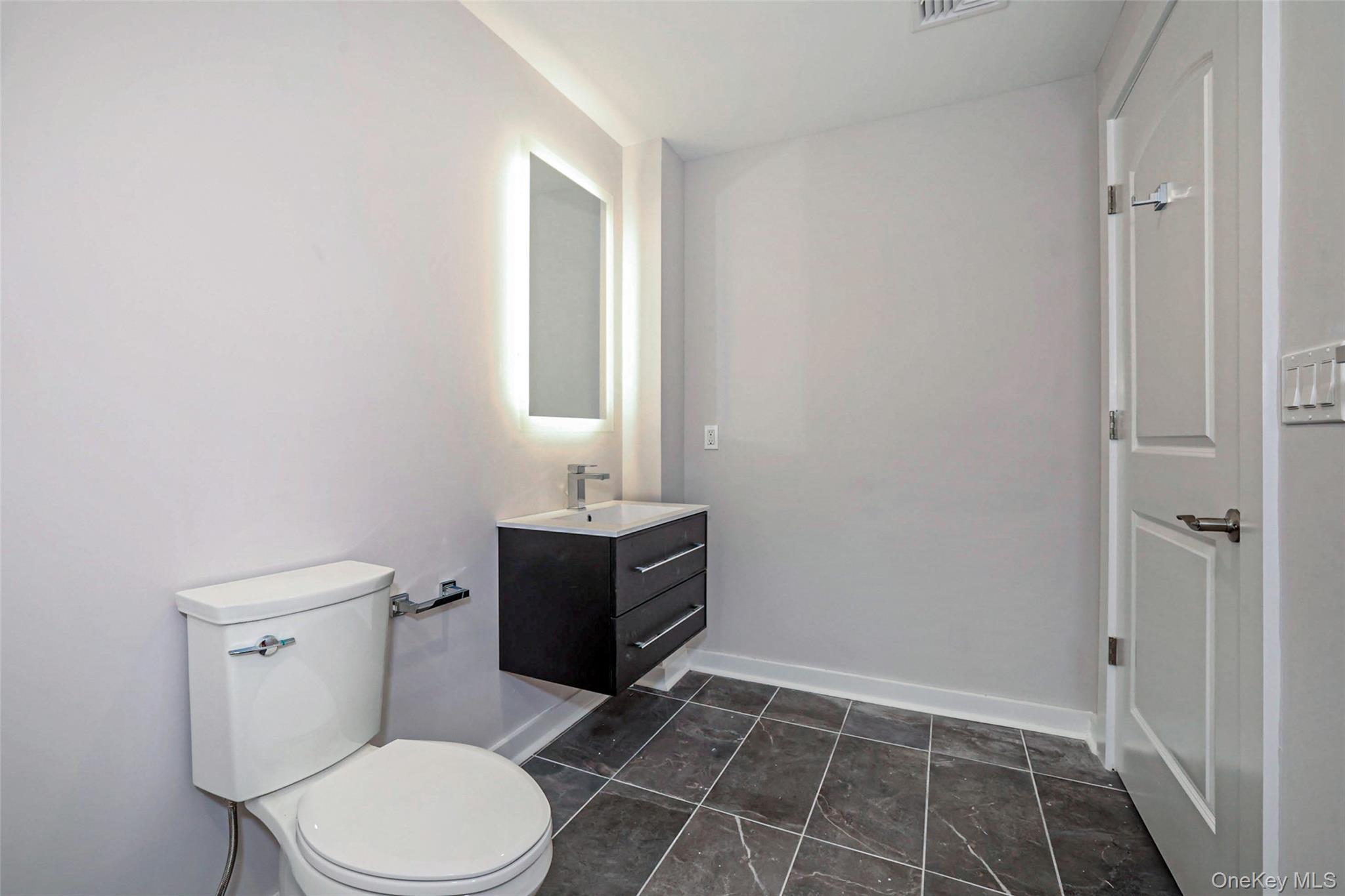 500 Commerce Street, Unit 108 Hawthorne, NY 10532 - Photo 12 of 17 Half bathroom with vanity and toilet