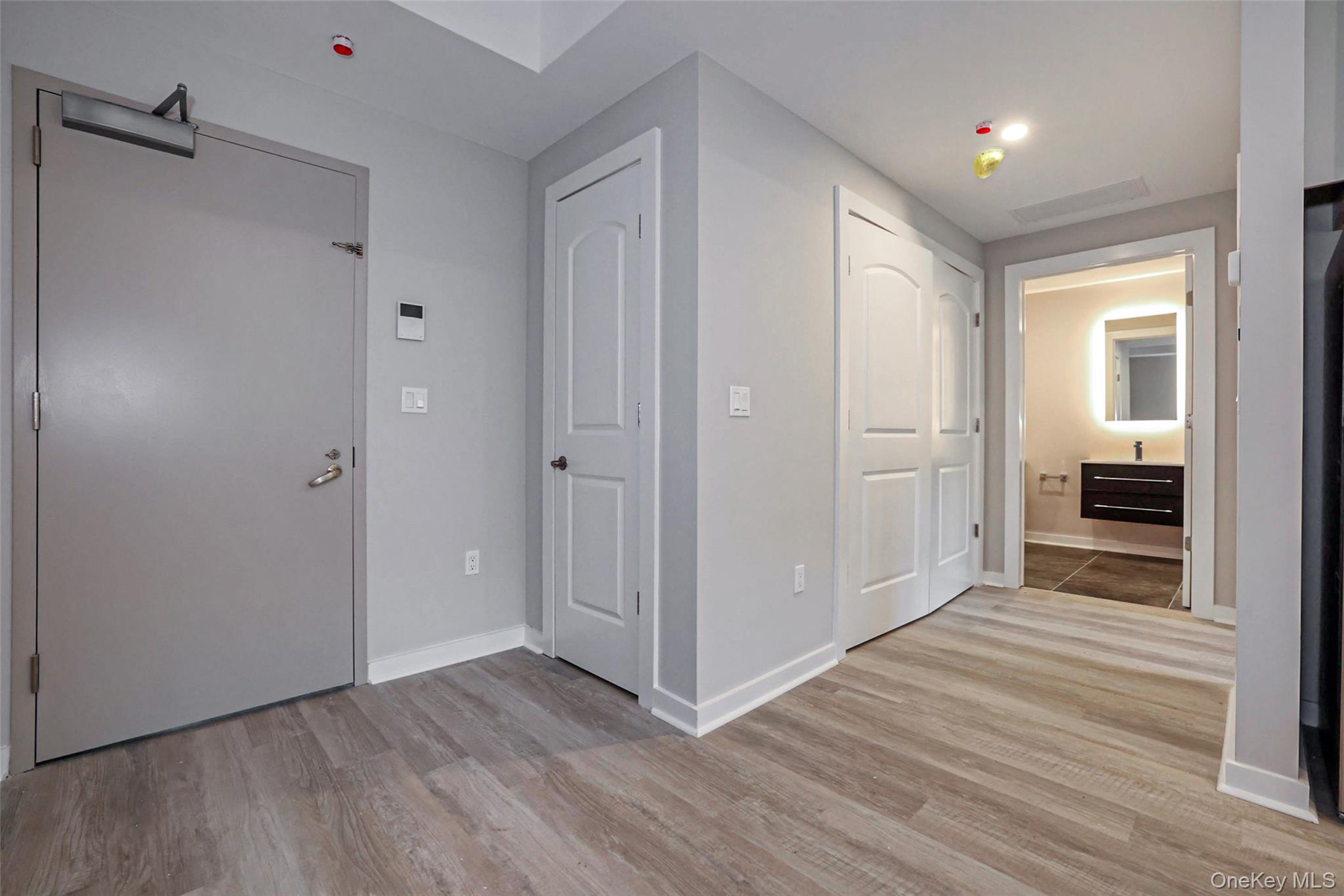500 Commerce Street, Unit 108 Hawthorne, NY 10532 - Photo 9 of 17 Hallway with light wood finished floors and baseboards