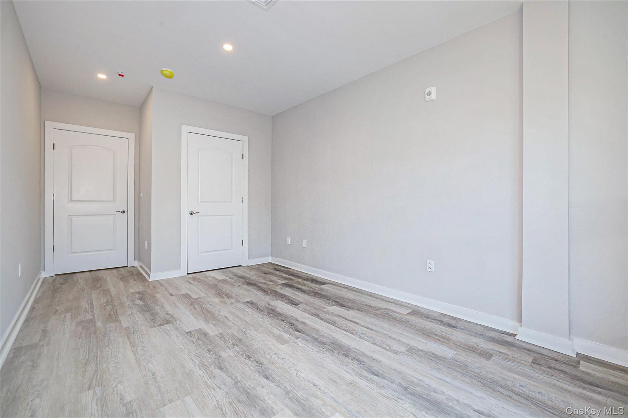 500 Commerce Street, Unit 108 Hawthorne, NY 10532 - Photo 10 of 17 Unfurnished bedroom with light wood finished floors and recessed lighting