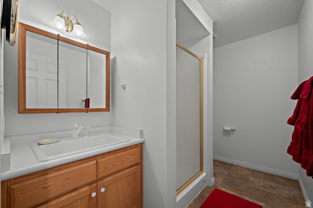 166 South Ridgeview Drive Orem, UT 84058 - Photo 29 of 38 Bathroom with wood-finish vanity, integrated sink, and white countertop