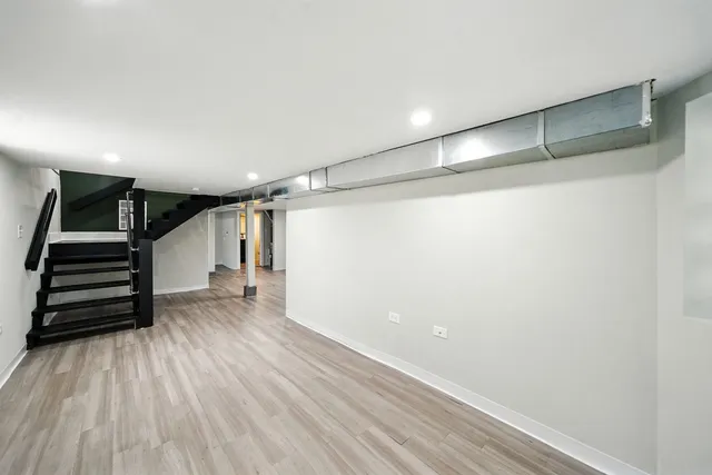 a view of a room with wooden floor and stairs