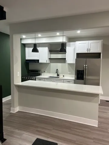 a kitchen with kitchen island a counter top and stainless steel appliances