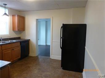 116 South Main Street Alburtis, PA 18011 - Photo 11 of 30 a kitchen with a refrigerator and a stove top oven