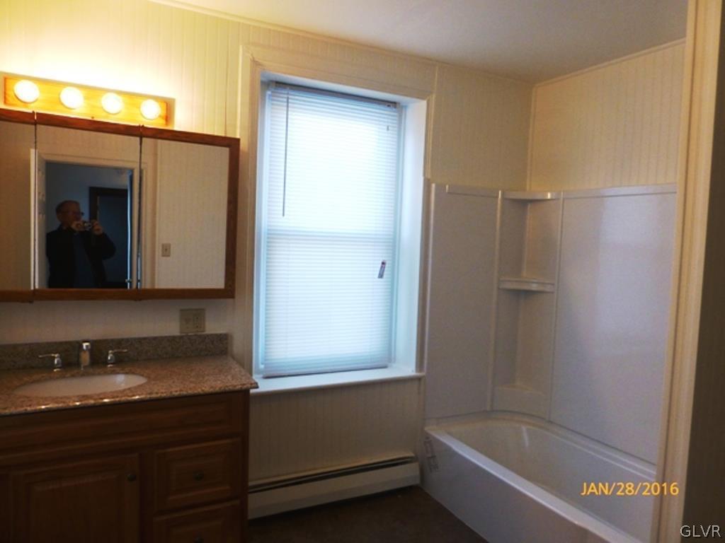 116 South Main Street Alburtis, PA 18011 - Photo 17 of 30 a bathroom with a granite countertop sink mirror and shower
