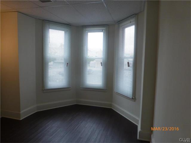 116 South Main Street Alburtis, PA 18011 - Photo 18 of 30 an empty room with wooden floor and windows
