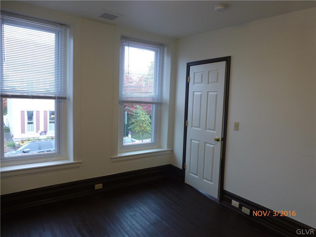 116 South Main Street Alburtis, PA 18011 - Photo 22 of 30 an empty room with wooden floor and windows