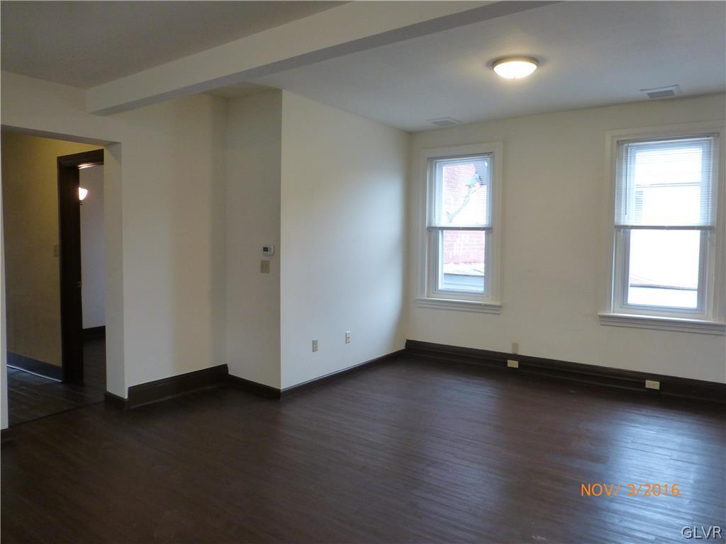 116 South Main Street Alburtis, PA 18011 - Photo 10 of 30 an empty room with wooden floor and windows