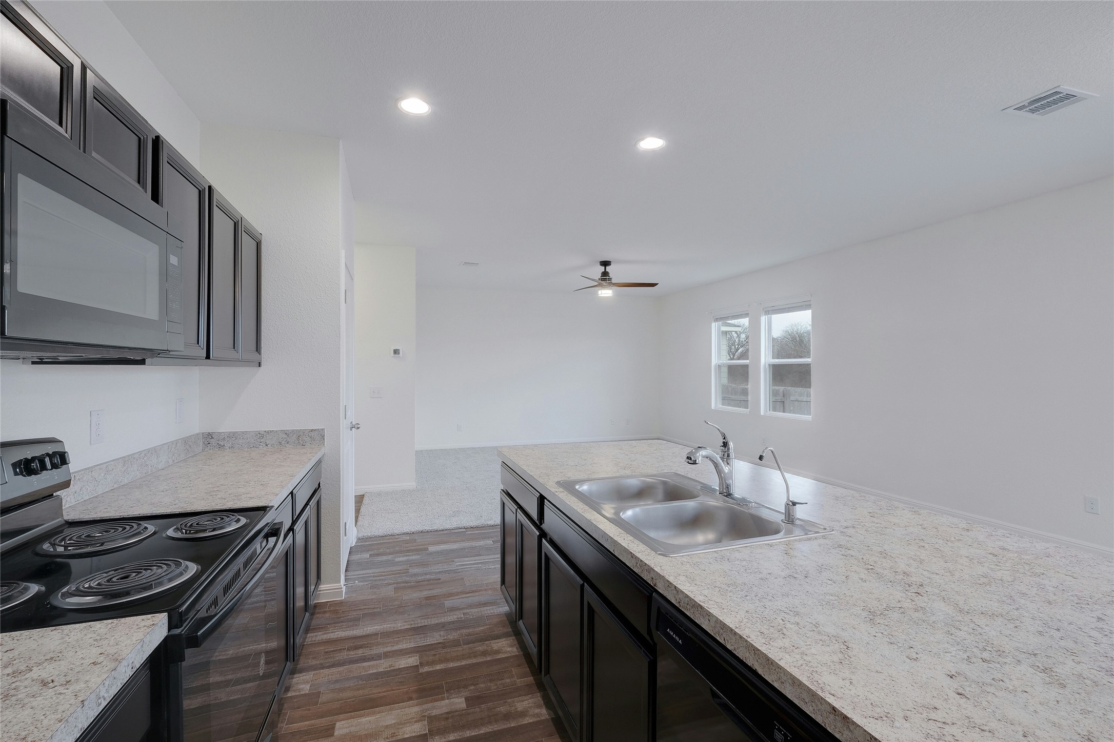 140 Satsuma Lane Kyle, TX 78640 - Photo 12 of 30 a kitchen with stainless steel appliances granite countertop a sink stove and cabinets