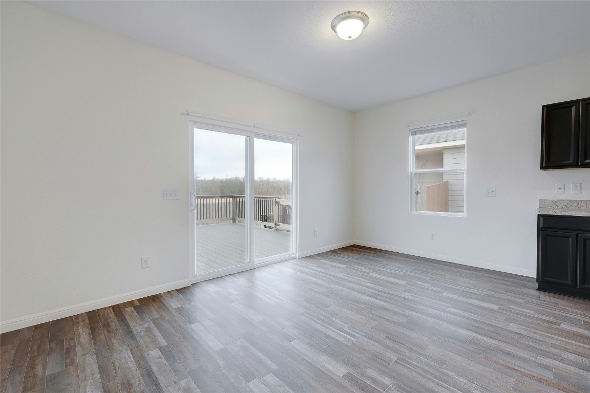 140 Satsuma Lane Kyle, TX 78640 - Photo 13 of 30 an empty room with wooden floor and windows