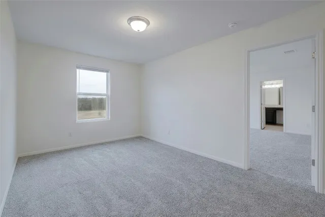 a view of kitchen with microwave and cabinets