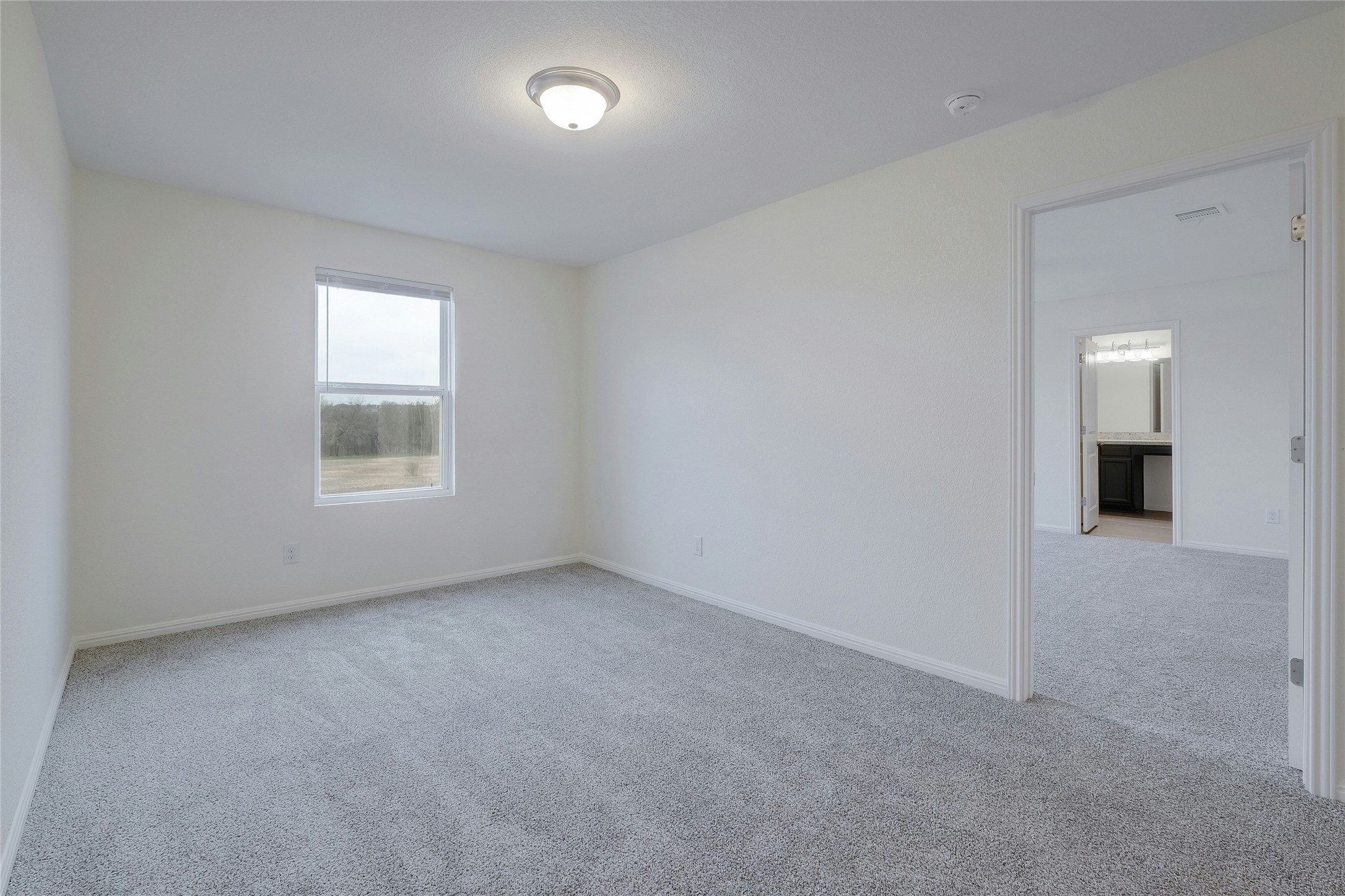 140 Satsuma Lane Kyle, TX 78640 - Photo 14 of 30 an empty room with a window and a kitchen