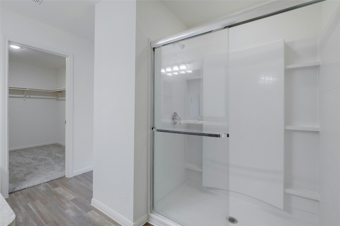 140 Satsuma Lane Kyle, TX 78640 - Photo 20 of 30 a bathroom with a glass shower door