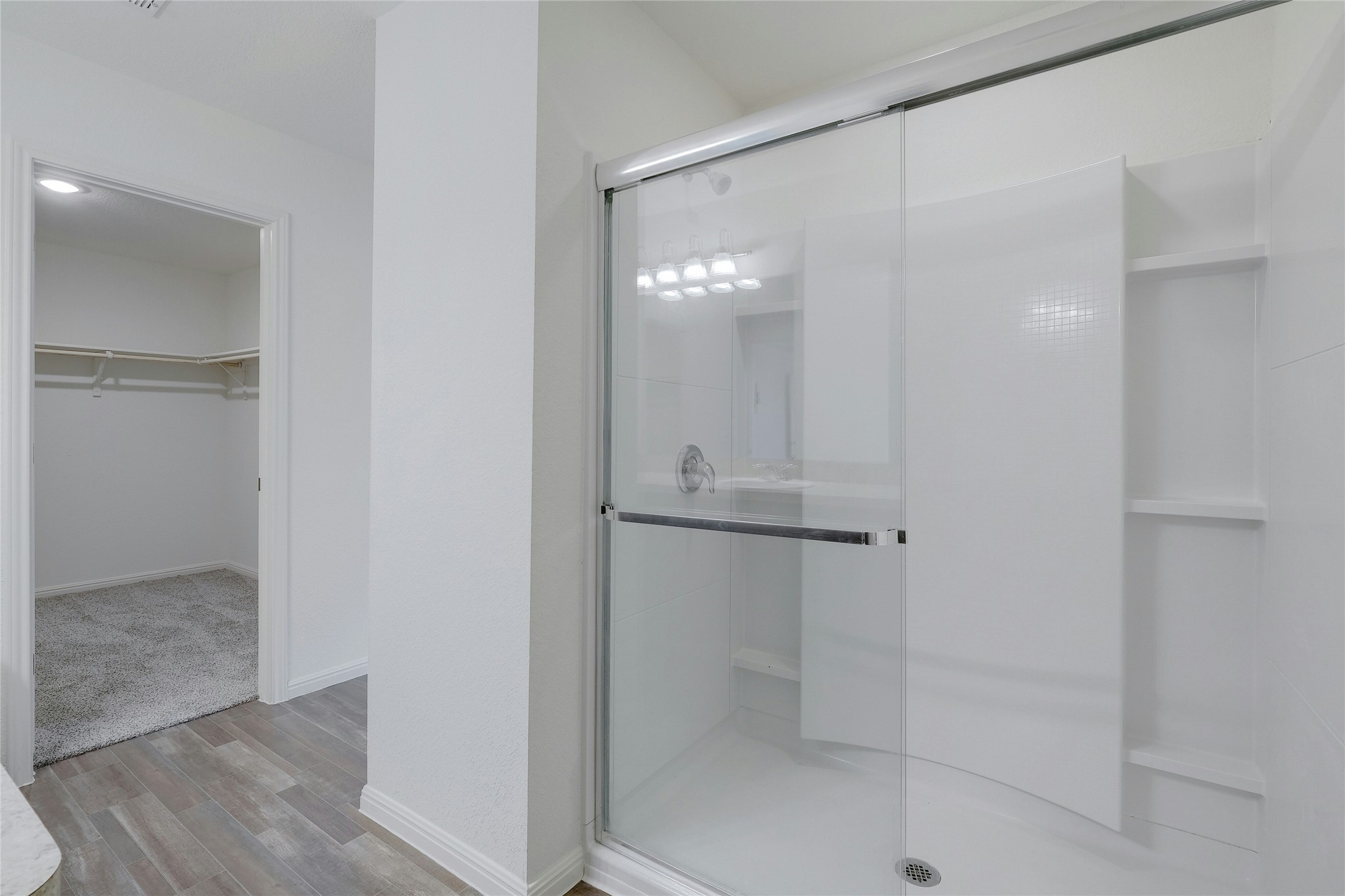 140 Satsuma Lane Kyle, TX 78640 - Photo 20 of 30 a bathroom with a glass shower door