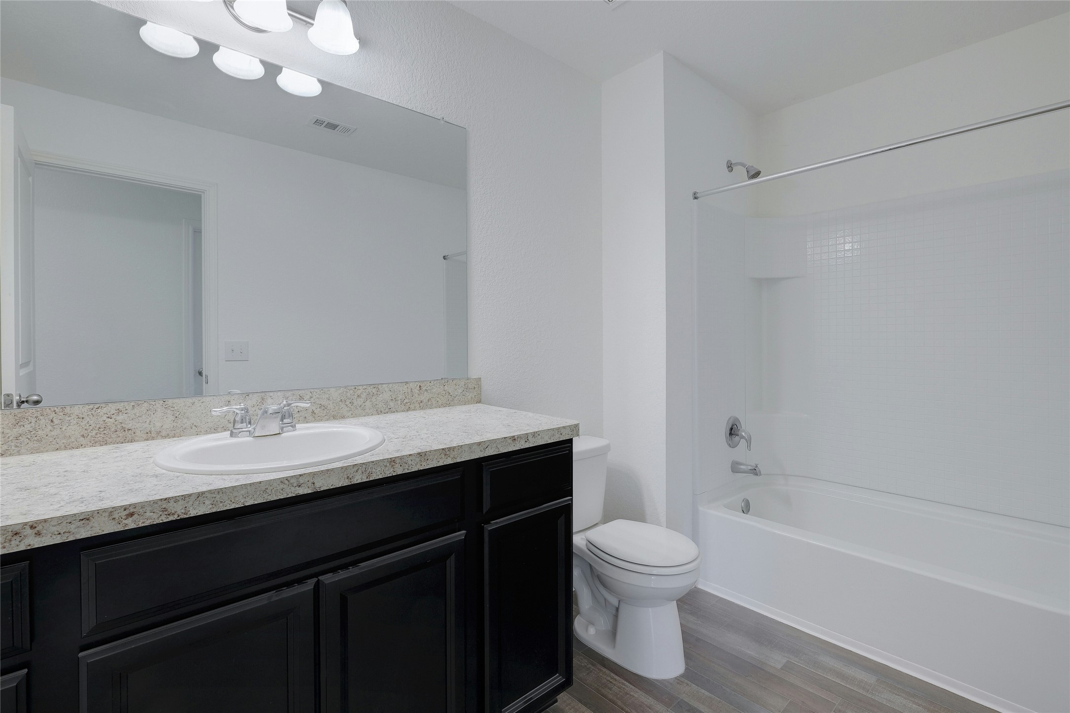 140 Satsuma Lane Kyle, TX 78640 - Photo 25 of 30 a bathroom with a granite countertop sink a toilet and shower