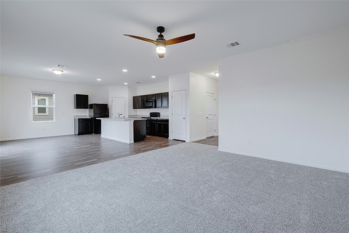 140 Satsuma Lane Kyle, TX 78640 - Photo 8 of 30 an empty room with fireplace and windows