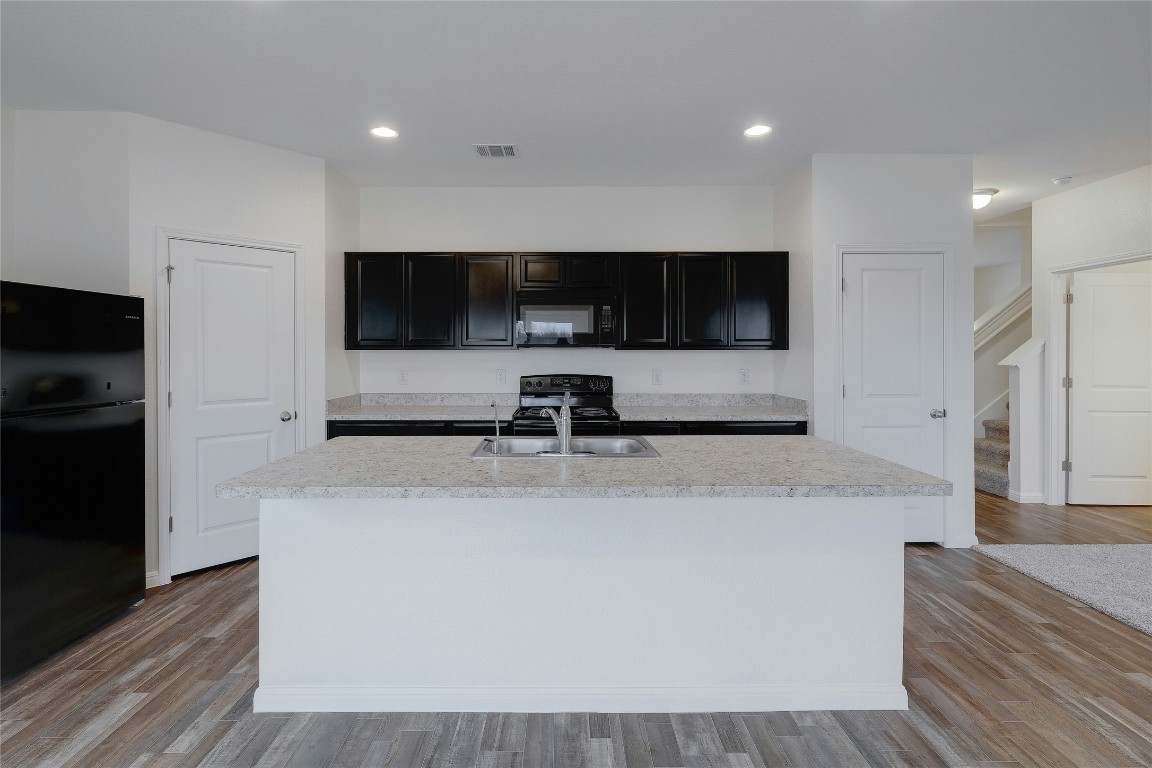 140 Satsuma Lane Kyle, TX 78640 - Photo 9 of 30 a view of living room with stainless steel appliances kitchen island a flat screen tv and a refrigerator