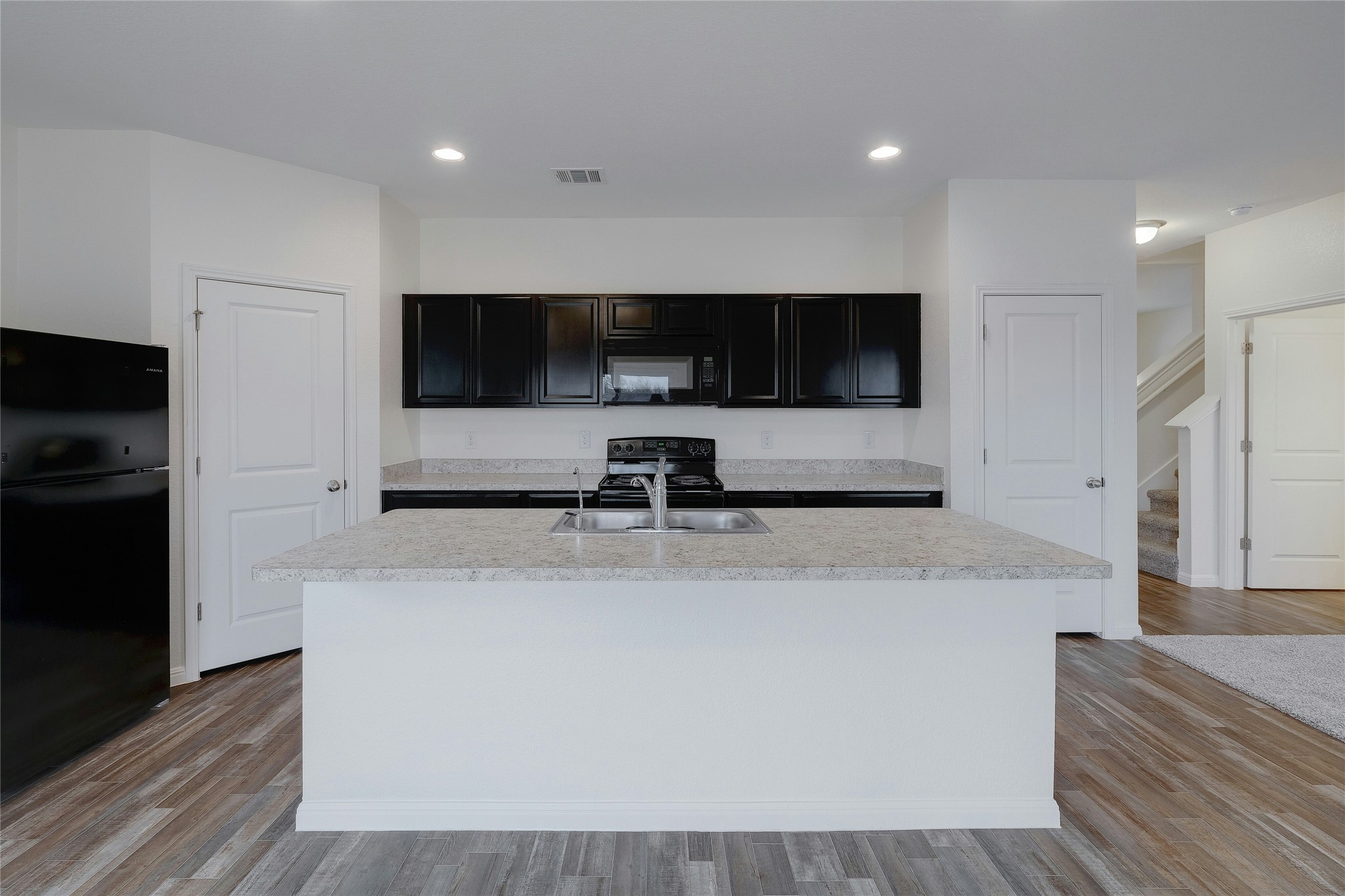 140 Satsuma Lane Kyle, TX 78640 - Photo 9 of 30 a view of living room with stainless steel appliances kitchen island a flat screen tv and a refrigerator