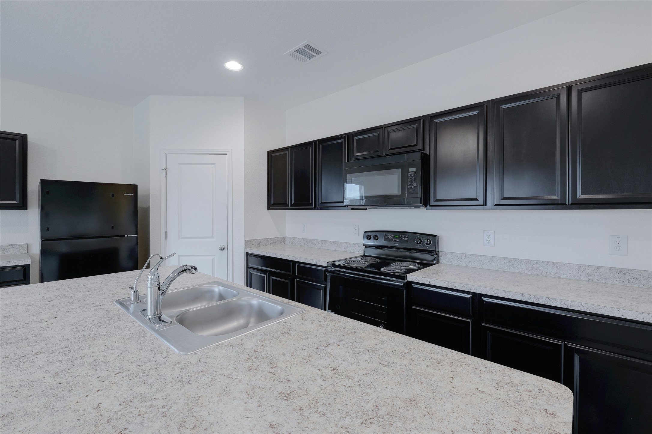140 Satsuma Lane Kyle, TX 78640 - Photo 10 of 30 a kitchen with granite countertop wooden cabinets and stainless steel appliances