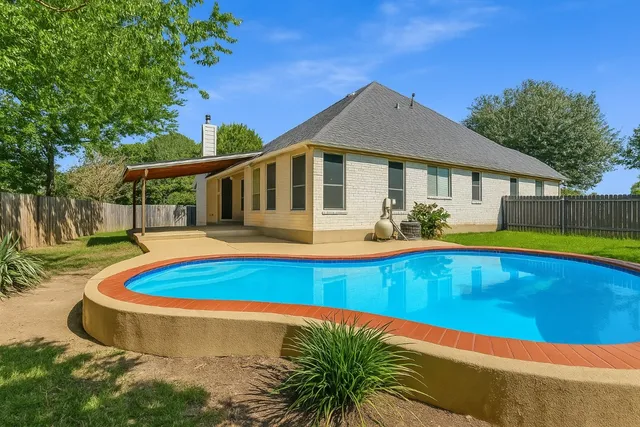a view of a house with swimming pool and porch