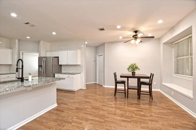 a kitchen with stainless steel appliances kitchen island granite countertop a sink and cabinets