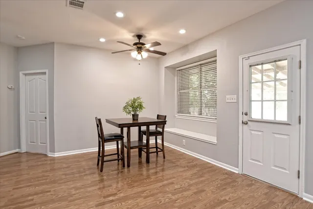 a view of a dining room with furniture window and wooden floor