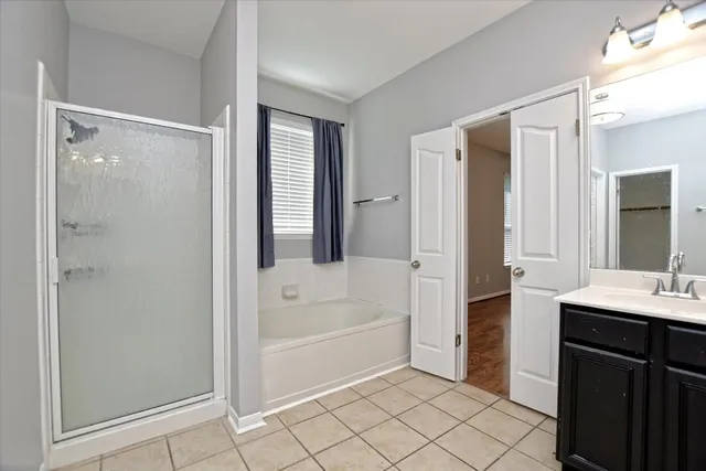 a spacious bathroom with a tub shower and sink