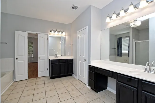 a bathroom with a sink vanity and a mirror