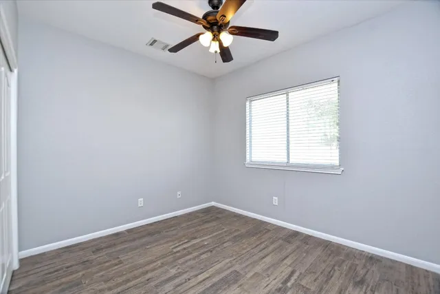 wooden floor in an empty room with a window