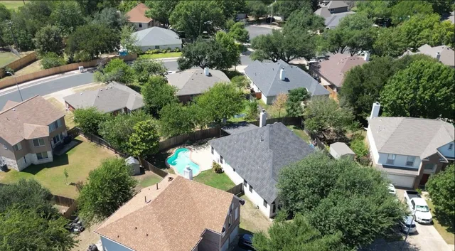 an aerial view of a house with outdoor space