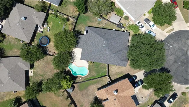 an aerial view of a house with a yard and garden