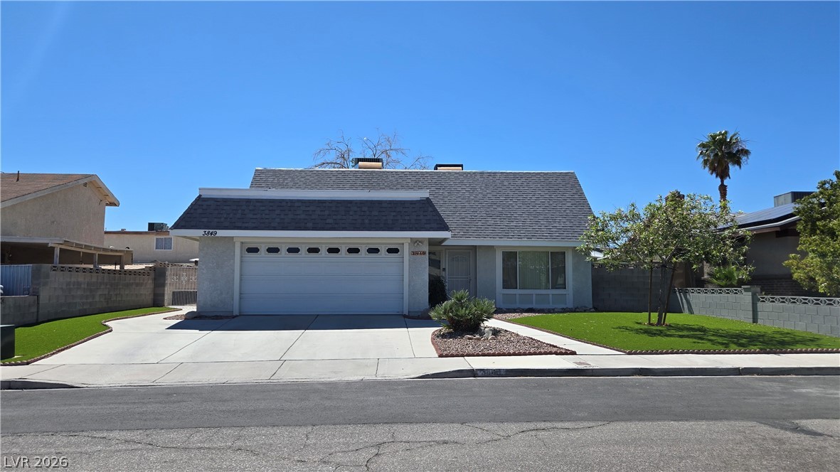 A well-kept front yard and driveway lead to this inviting residential property.