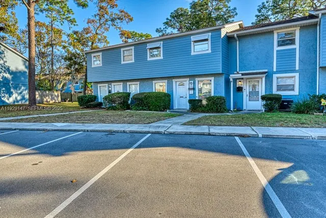 a view of a brick house with a yard