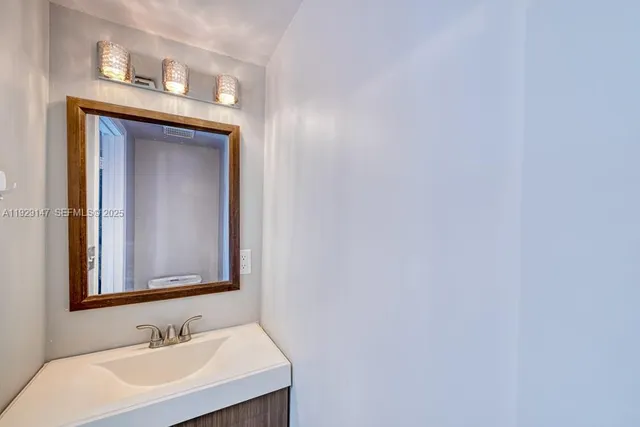 an empty room with a window and wooden floor