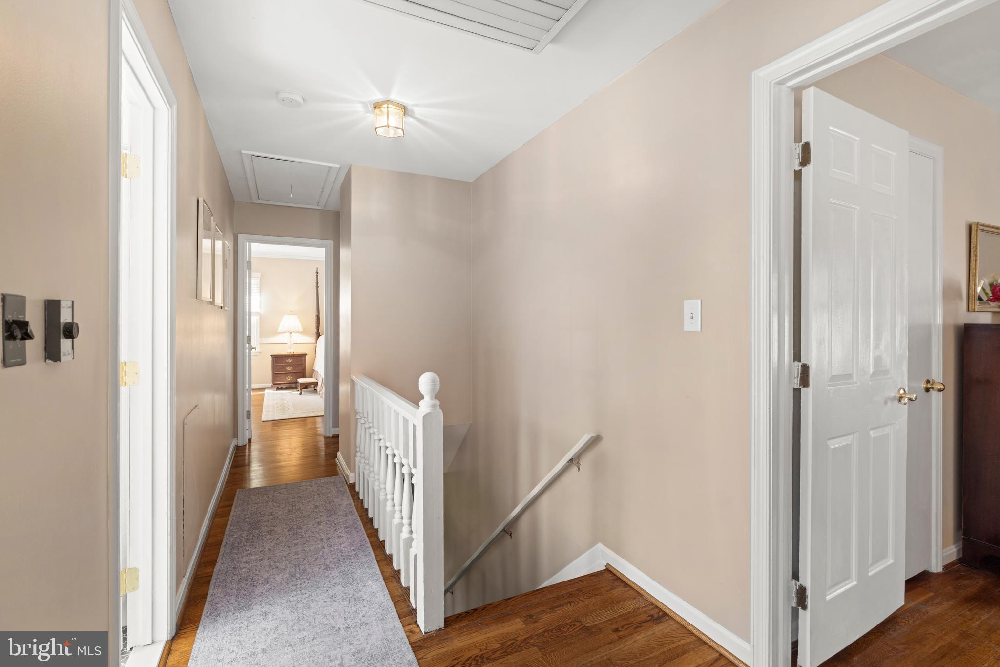13714 Harcum Road Phoenix, MD 21131 - Photo 26 of 61 a view of a hallway with an entryway and wooden floor