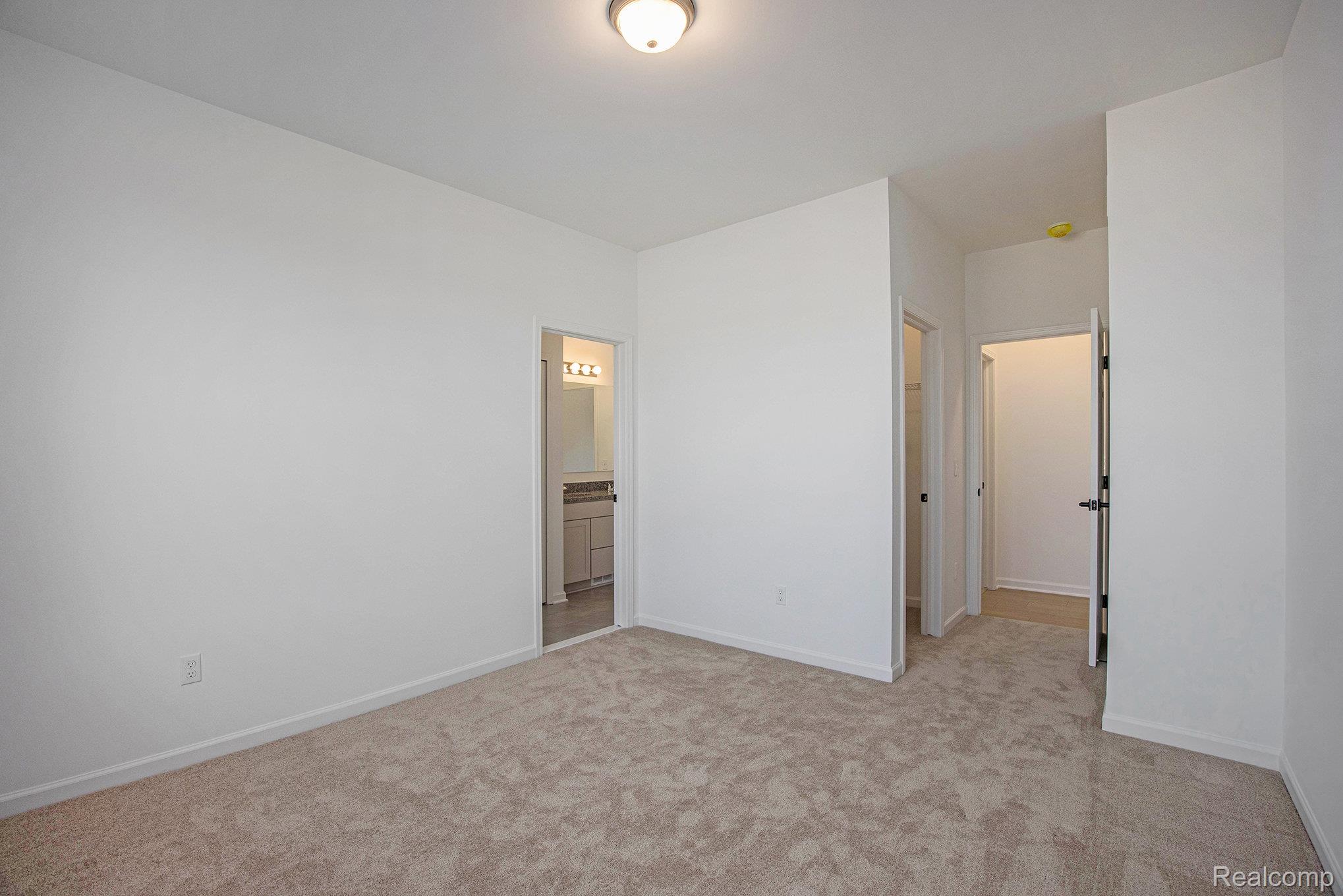68788 Place Road New Haven, MI 48050 - Photo 14 of 29 Unfurnished bedroom featuring light colored carpet and a spacious closet